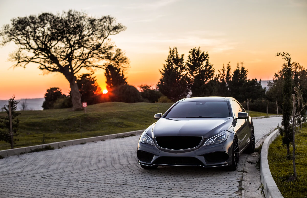 grey luxury sedan car sunset